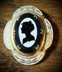 Antique Victorian gold and white colored brooch with black and white glass cameo
