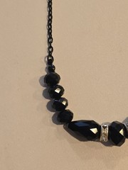 vintage-style beaded necklace black faceted beads and silver-toned spacers.