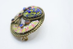 Antique Egyptian Revival winged scarab brooch featuring vibrant enamel work