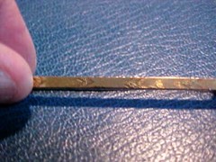 Long Tie Bar or Pin with a Gold Top 2″ long.