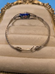 Mexico Alpaca silver hinged bangle bracelet featuring a colorful enameled flower