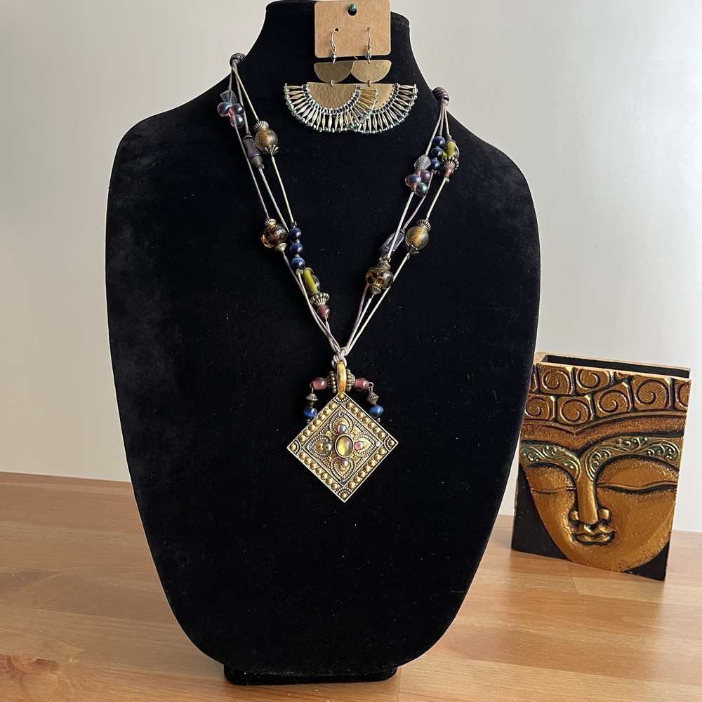 Vintage-style beaded necklace with a square, metal pendant paired with earrings