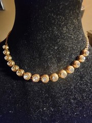 Vintage tennis-style chain necklace with round stones in a bezel setting.