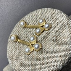 Pierced faux pearl cabochon dangle earrings in gold tone metal