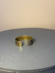 brassy gold tone fish design bangle bracelet