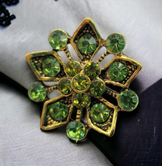 Gold Tone Rhinestone Green Ornate Costume Jewelry Floral Snowflake Brooch Pin