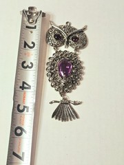a Rare 1970s Articulated Owl Pendant featuring purple faux-amethyst glass…