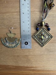 Vintage-style beaded necklace with a square, metal pendant paired with earrings