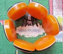 Vintage orange Acrylic bracelet with Budha images from around the world