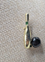 Vintage signed Gerry’s bowling ball brooch. Gold with green rhinestone.