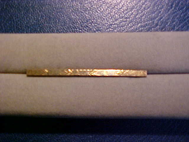 Long Tie Bar or Pin with a Gold Top 2″ long.