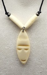 Vintage 18″ vinyl necklace with shield shape bone face pendant