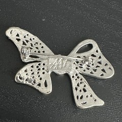 AAI Silver-tone Ribbon Bow Brooch Featuring Intricate Openwork Filigree Details.