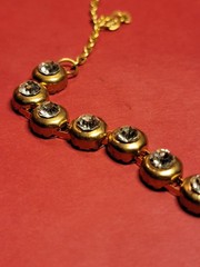 Vintage tennis-style chain necklace with round stones in a bezel setting.