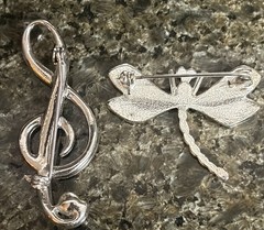 2 vintage unbranded Clear Rhinestone brooches in silvertone: G Clef & Dragonfly