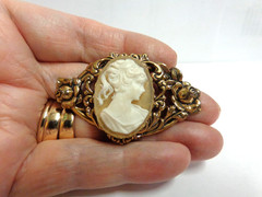 vintage gold tone cameo pin in floral frame sz 2 in wide wgt 9.6 grams girl bust