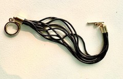 multi-strand bracelet features black and gold tone textured cords