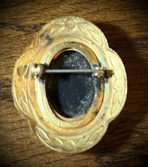 Antique Victorian gold and white colored brooch with black and white glass cameo