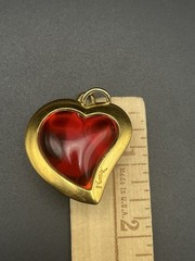 VTG 80’s Yves Saint Laurent (YSL) gold-tone metal and red resin heart pendant.