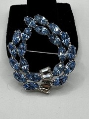 Vintage B. David silver tone brooch featuring rhinestones