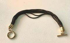 multi-strand bracelet features black and gold tone textured cords