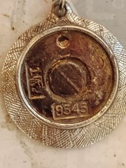 vintage 8545 charm.It is designed as a round textured metal meant to