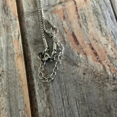 Faux pearl filigree cone necklace in silver tone metal on box chain