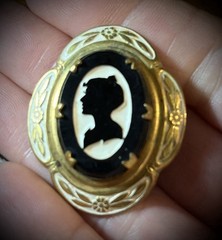 Antique Victorian gold and white colored brooch with black and white glass cameo