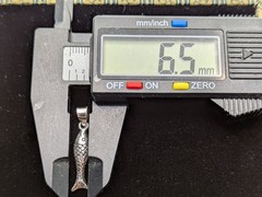 925 Sterling Silver Fish Pendant / Charm. Weighs 1.1 Grams. 1.13″ Long.