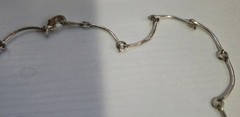 9 multicolor heart caged bead charms on a silvertone necklace