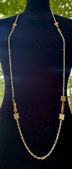 vintage-style necklace features amber-colored barrel beads and gold-tone chain