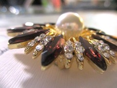 gold tone starburst brooch with purple & clear zircons + a large faux pearl