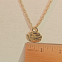Bright gold tone Noah’s Ark pendant and 24 inch gold tone chain necklace