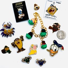 VTG LOT 12 CARTOON CHARACTER BRAND PINS – WARNER BROS, LOONEY TOONS, SMURF, AVON
