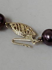 Genuine knotted pearl necklace with 14-karat yellow gold clasp