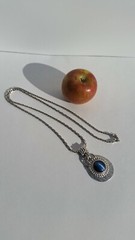 Blue Tiger Eye Cabochon style pendant with a convex formed silver toned reverse