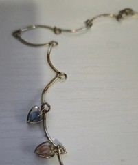 9 multicolor heart caged bead charms on a silvertone necklace
