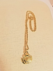 Bright gold tone Noah’s Ark pendant and 24 inch gold tone chain necklace