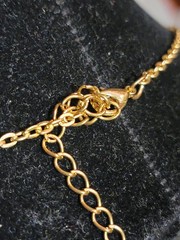 Vintage tennis-style chain necklace with round stones in a bezel setting.