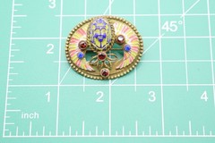 Antique Egyptian Revival winged scarab brooch featuring vibrant enamel work