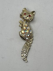 Bejeweled Feline Brooch Gold Tone With Man Made Aurora Borealis And Red Stones