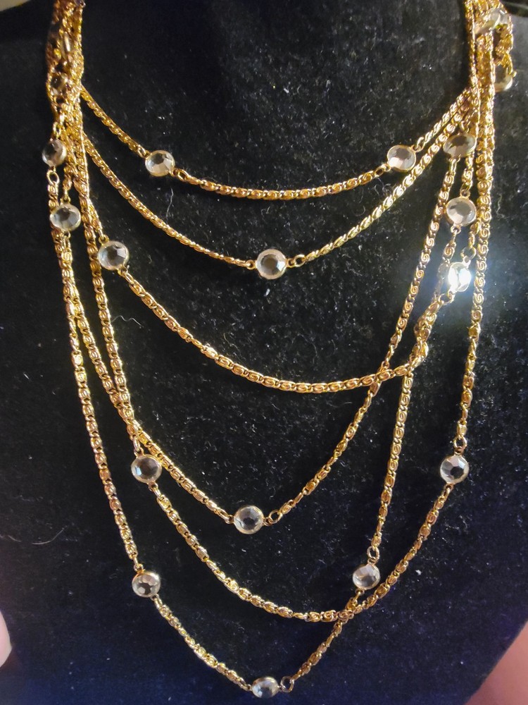 Vintage gold-tone necklace features length and crystals