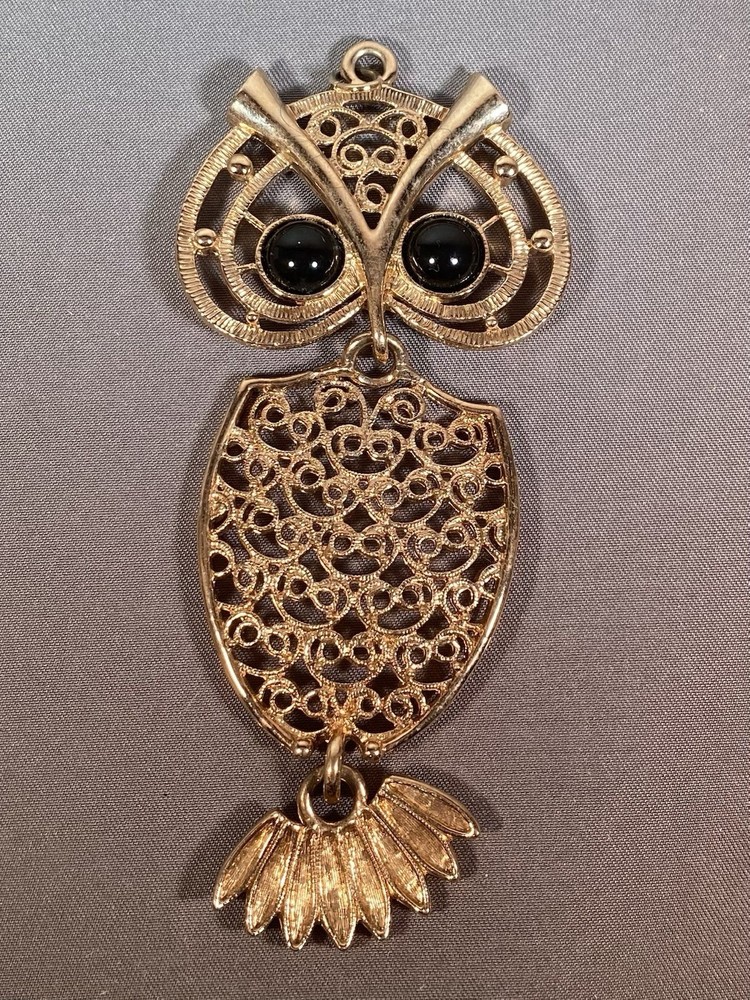 Sarah Coventry gold-toned owl pendant with black cabochon eyes.