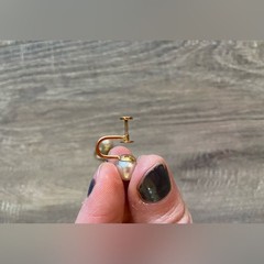 Vintage women’s stamped metal, gold color, and faux pearl earrings
