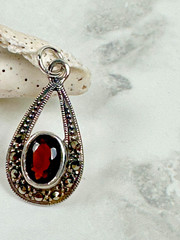Sterling Silver Teardrop Pendant with Reddish Brown Faceted Oval Stone – 1″