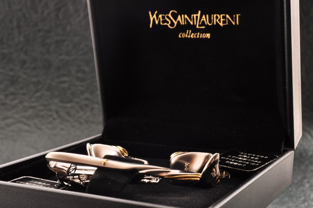 Near mint, gold and Cufflinks and silver tie clip, “Yves Saint Laurent”, case.