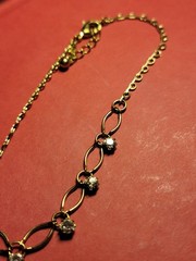 Vintage Avon Bracelet open pinched oval links light gold tone clear rhinestones.