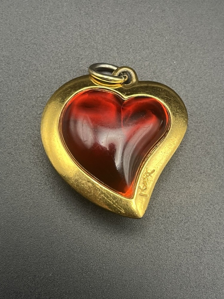 VTG 80’s Yves Saint Laurent (YSL) gold-tone metal and red resin heart pendant.