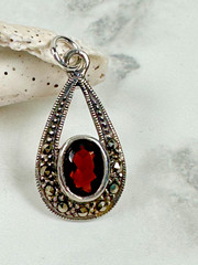 Sterling Silver Teardrop Pendant with Reddish Brown Faceted Oval Stone – 1″
