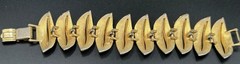 VINTAGE ART ARTHUR PEPPER BRACELET GOLD TONE WITH WHITE FOLD OVER CLASP SIGNED